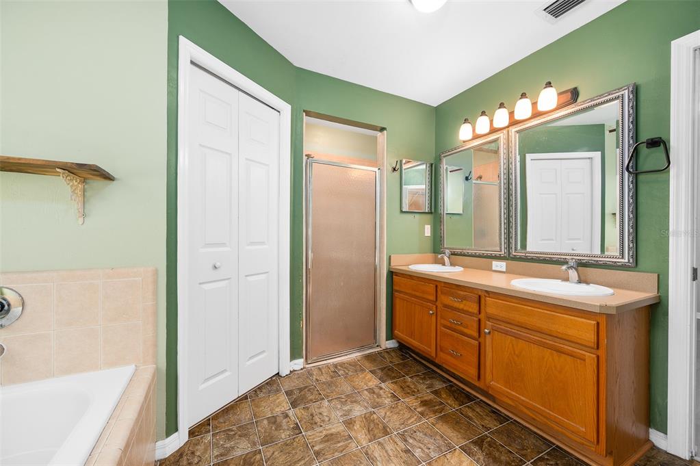 7462 Southwest 84th Drive Gainesville, FL 32608 - Photo 17 of 42 a bathroom with a double vanity sink mirror and bathtub
