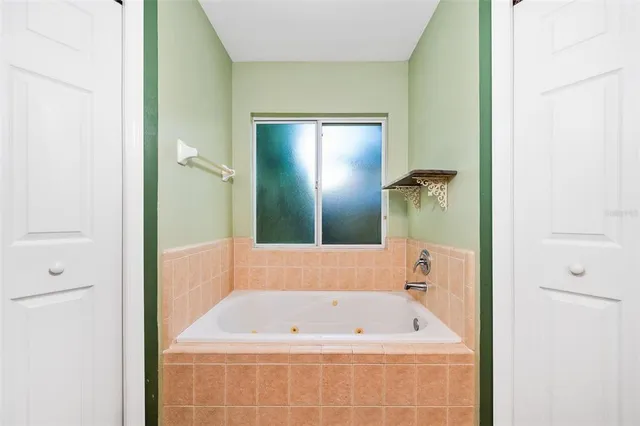a bathroom with a tub a shower and a sink