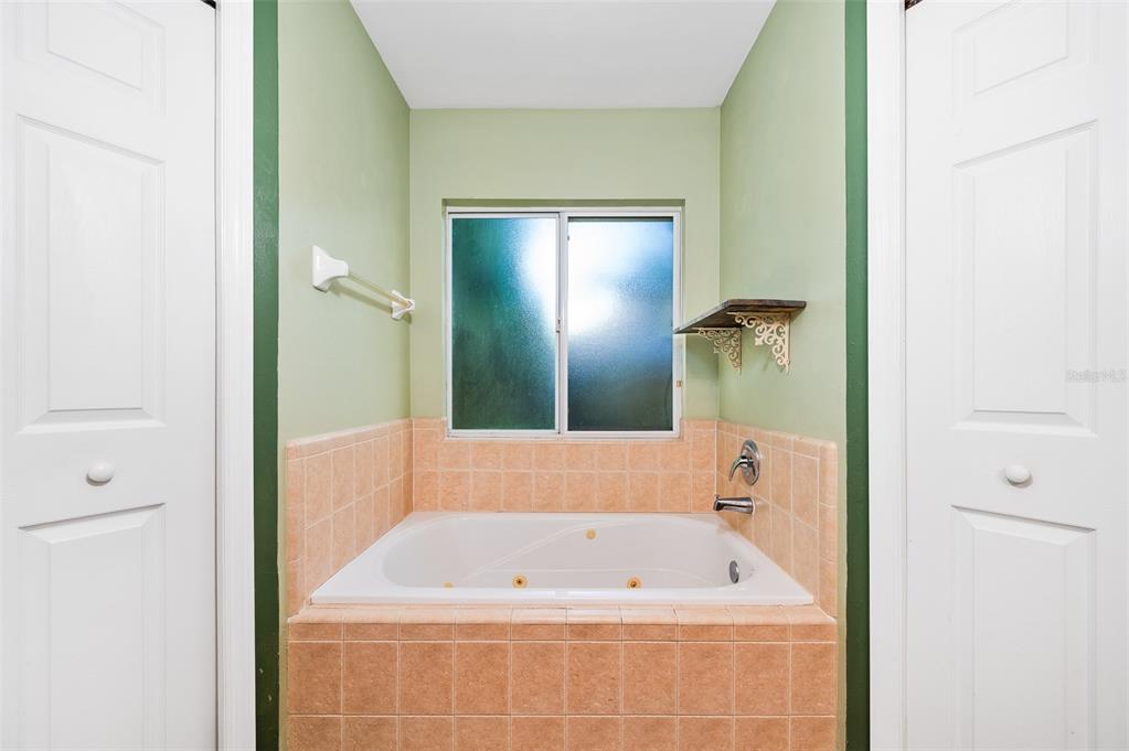 7462 Southwest 84th Drive Gainesville, FL 32608 - Photo 19 of 42 a bathroom with a tub a shower and a sink