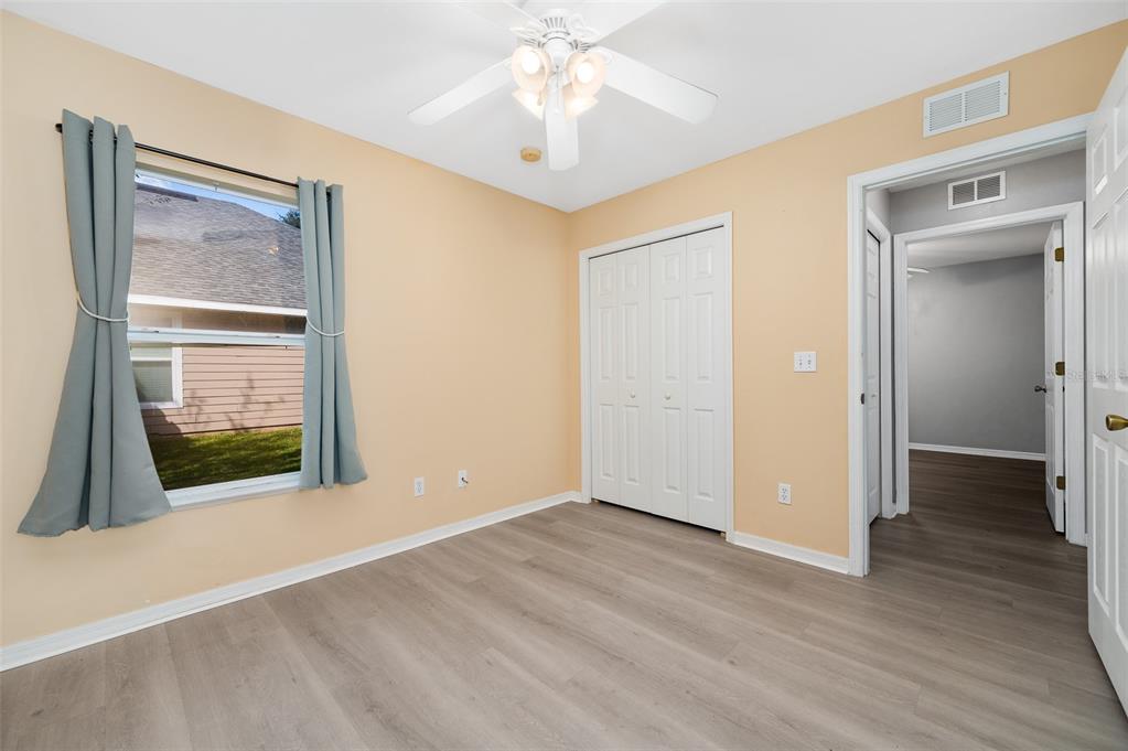 7462 Southwest 84th Drive Gainesville, FL 32608 - Photo 22 of 42 a view of an empty room with wooden floor and a window