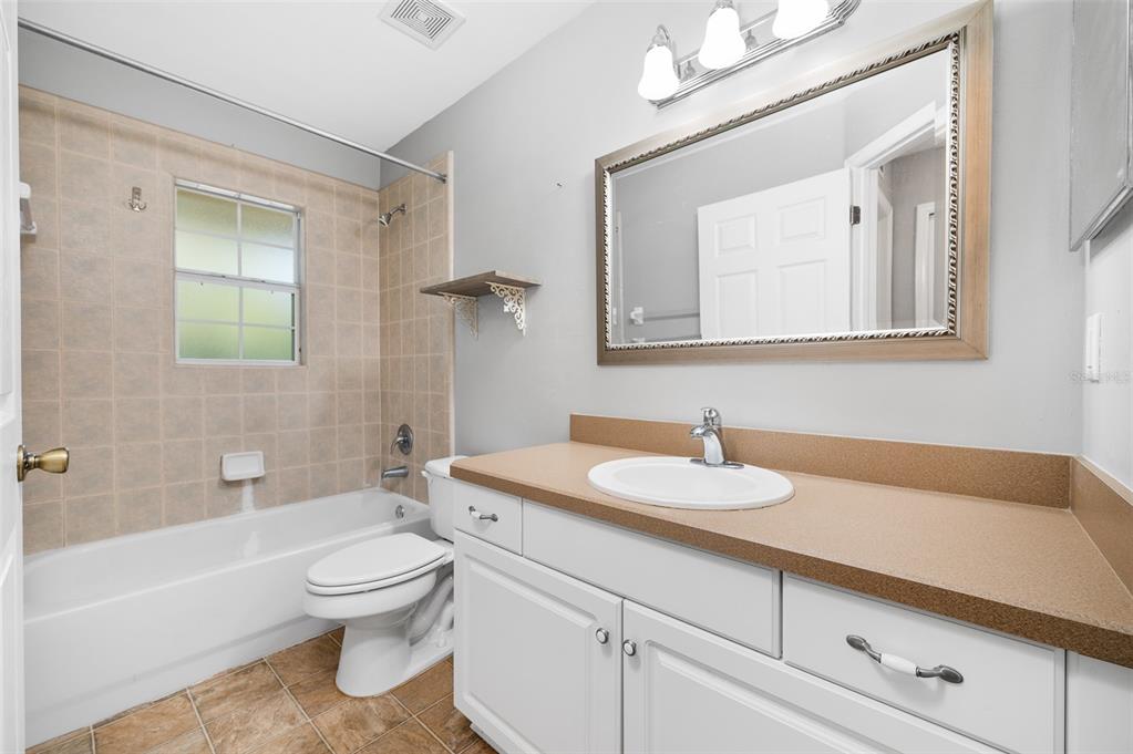 7462 Southwest 84th Drive Gainesville, FL 32608 - Photo 24 of 42 a bathroom with a sink a toilet and shower