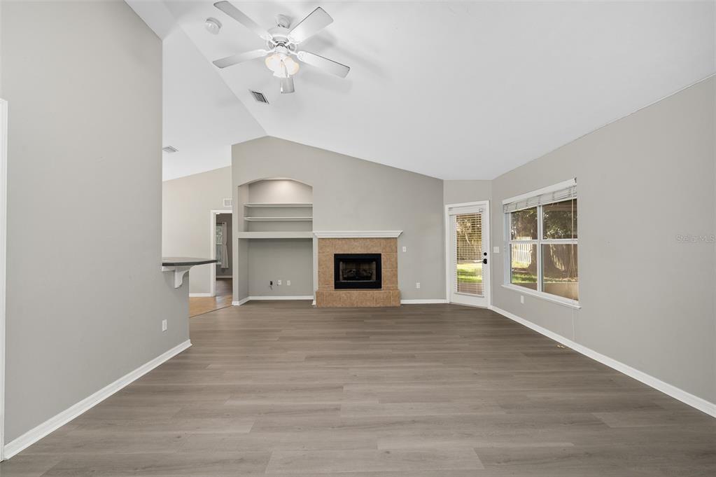 7462 Southwest 84th Drive Gainesville, FL 32608 - Photo 5 of 42 a view of an empty room with a fireplace and a window