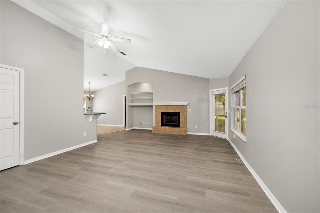 7462 Southwest 84th Drive Gainesville, FL 32608 - Photo 7 of 42 an empty room with windows and fireplace