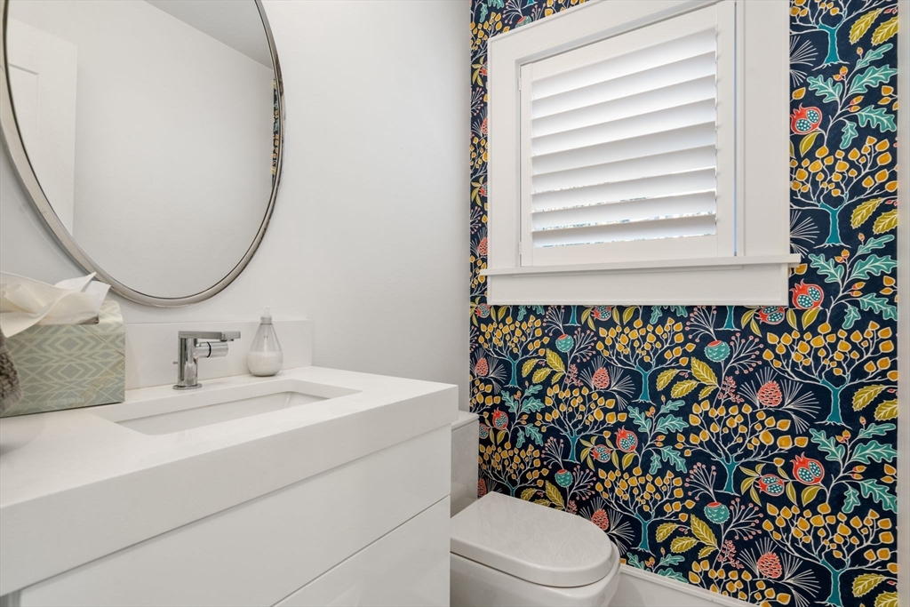 1404 Centre Street Newton, MA 02459 - Photo 17 of 42 a bathroom with a sink a toilet and a mirror