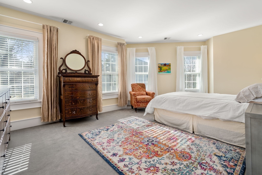 1404 Centre Street Newton, MA 02459 - Photo 19 of 42 a spacious bedroom with a bed a table and chair