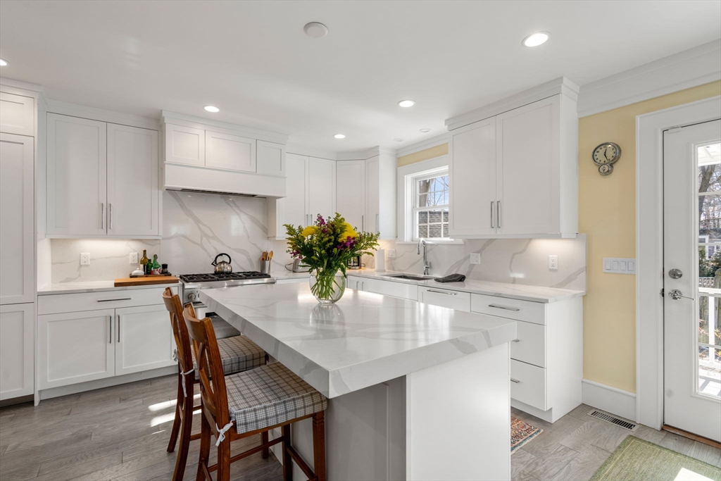 1404 Centre Street Newton, MA 02459 - Photo 2 of 42 a kitchen with kitchen island a table and chairs in it