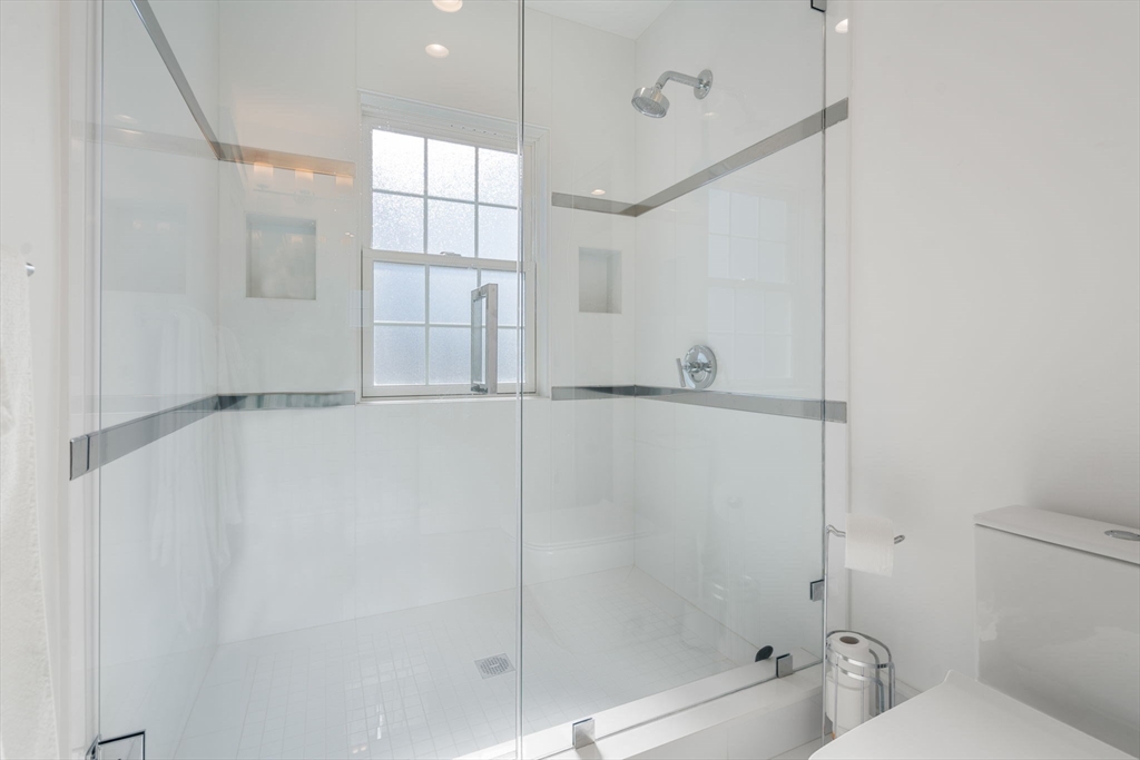 1404 Centre Street Newton, MA 02459 - Photo 22 of 42 a bathroom with a bathtub and a shower