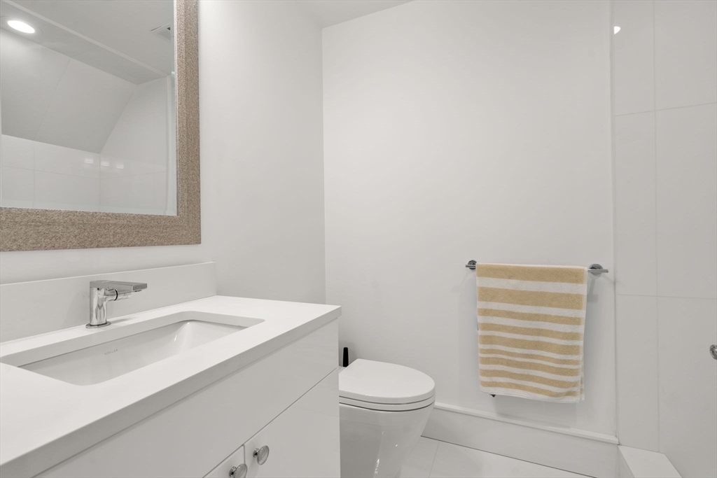 1404 Centre Street Newton, MA 02459 - Photo 23 of 42 a bathroom with a sink a toilet and vanity