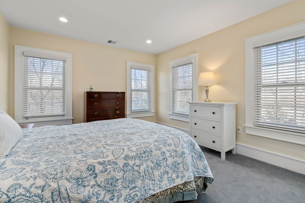 1404 Centre Street Newton, MA 02459 - Photo 25 of 42 a bedroom with a bed and a dresser next to a window