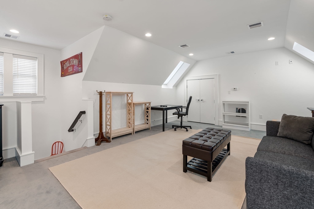 1404 Centre Street Newton, MA 02459 - Photo 29 of 42 a living room with furniture a table and white walls