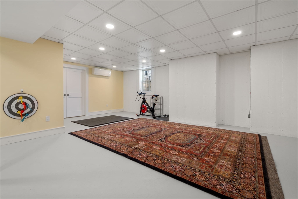 1404 Centre Street Newton, MA 02459 - Photo 30 of 42 a bedroom with a bed and a chandelier