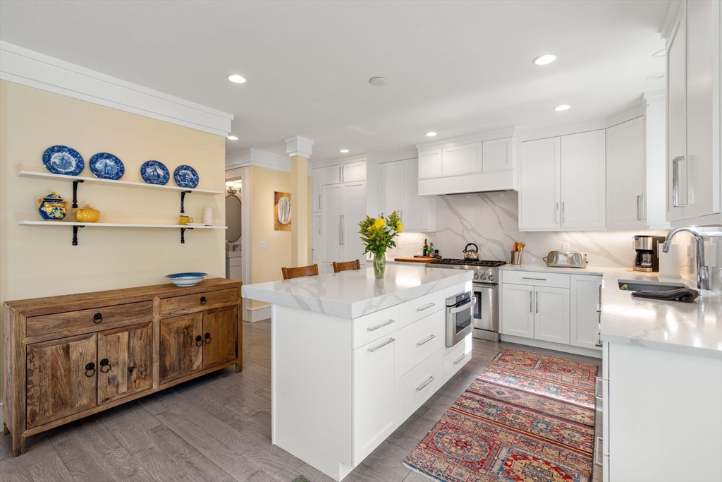 1404 Centre Street Newton, MA 02459 - Photo 5 of 42 a kitchen with a sink stove and cabinets