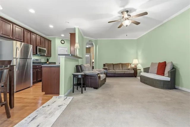 a living room with furniture and a kitchen view