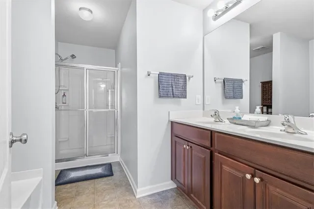 a bathroom with a shower a toilet and a sink