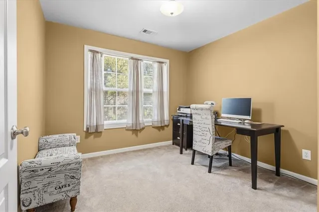 a bed sitting in a bedroom next to a window