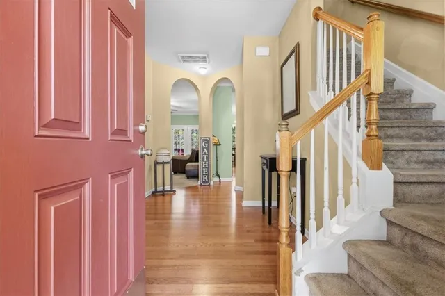 a view of entryway and hall with wooden floor