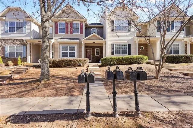 a front view of a building with lots of trees