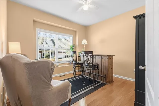 a living room with furniture and a floor to ceiling window