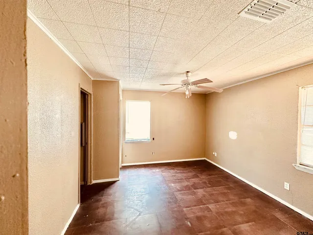 an empty room with windows and entrance