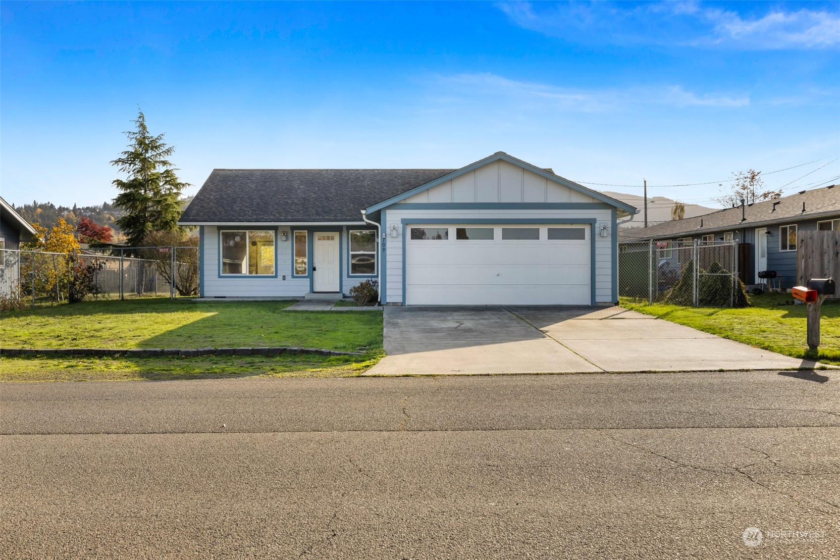 709 East Fir Street Sequim, WA 98382 - Photo 1 of 29 a view of a house with a big yard and large trees
