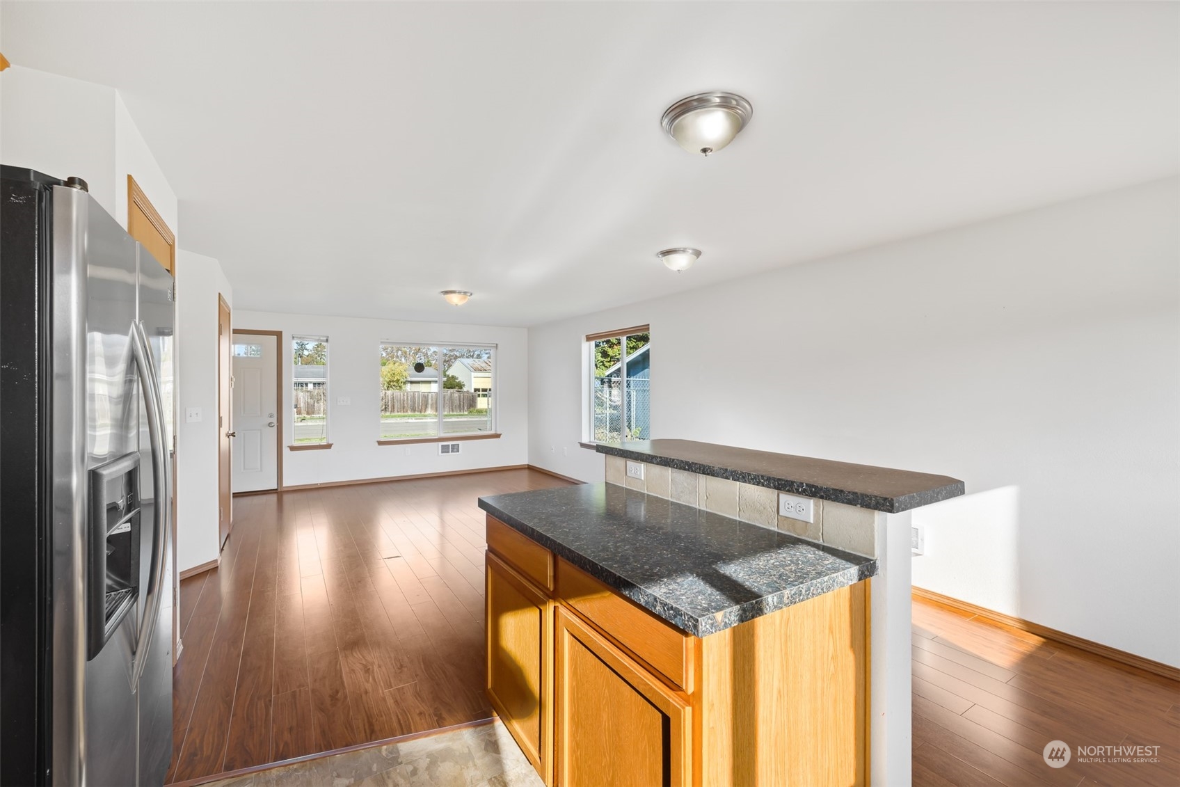 709 East Fir Street Sequim, WA 98382 - Photo 14 of 29 a view of a hallway to an empty room with wooden floor and a window