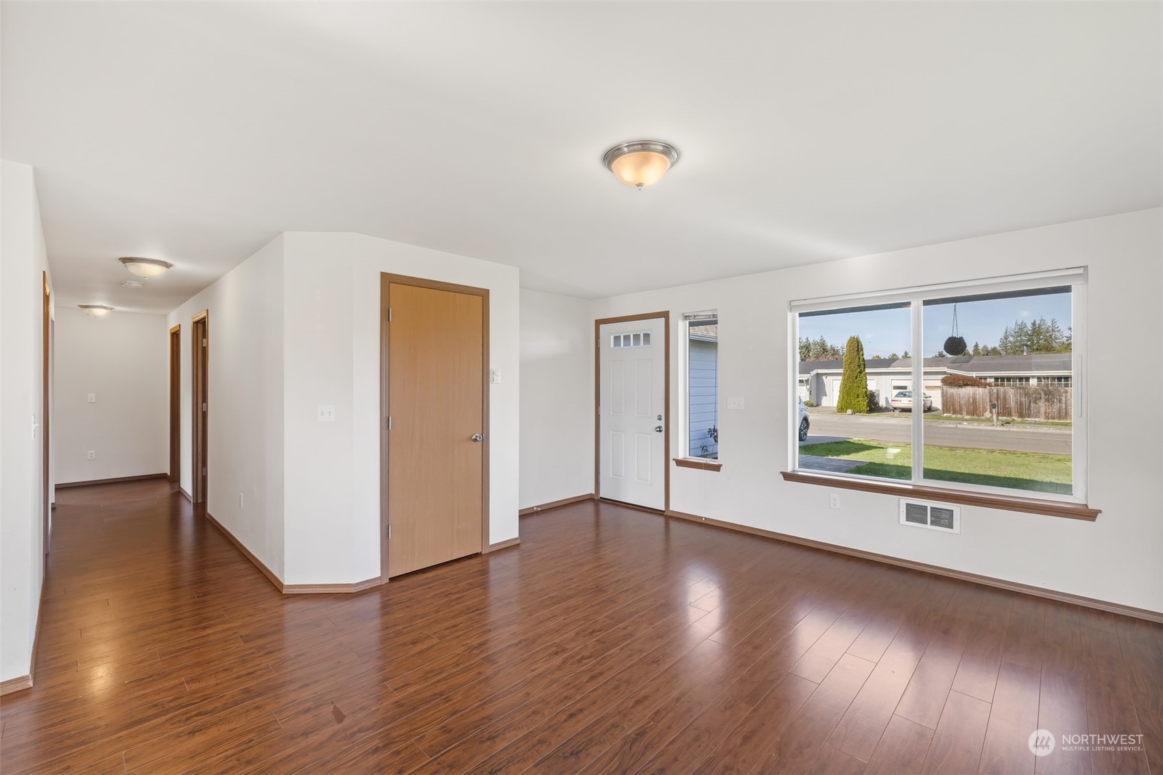 709 East Fir Street Sequim, WA 98382 - Photo 15 of 29 a view of a big room with wooden floor and windows