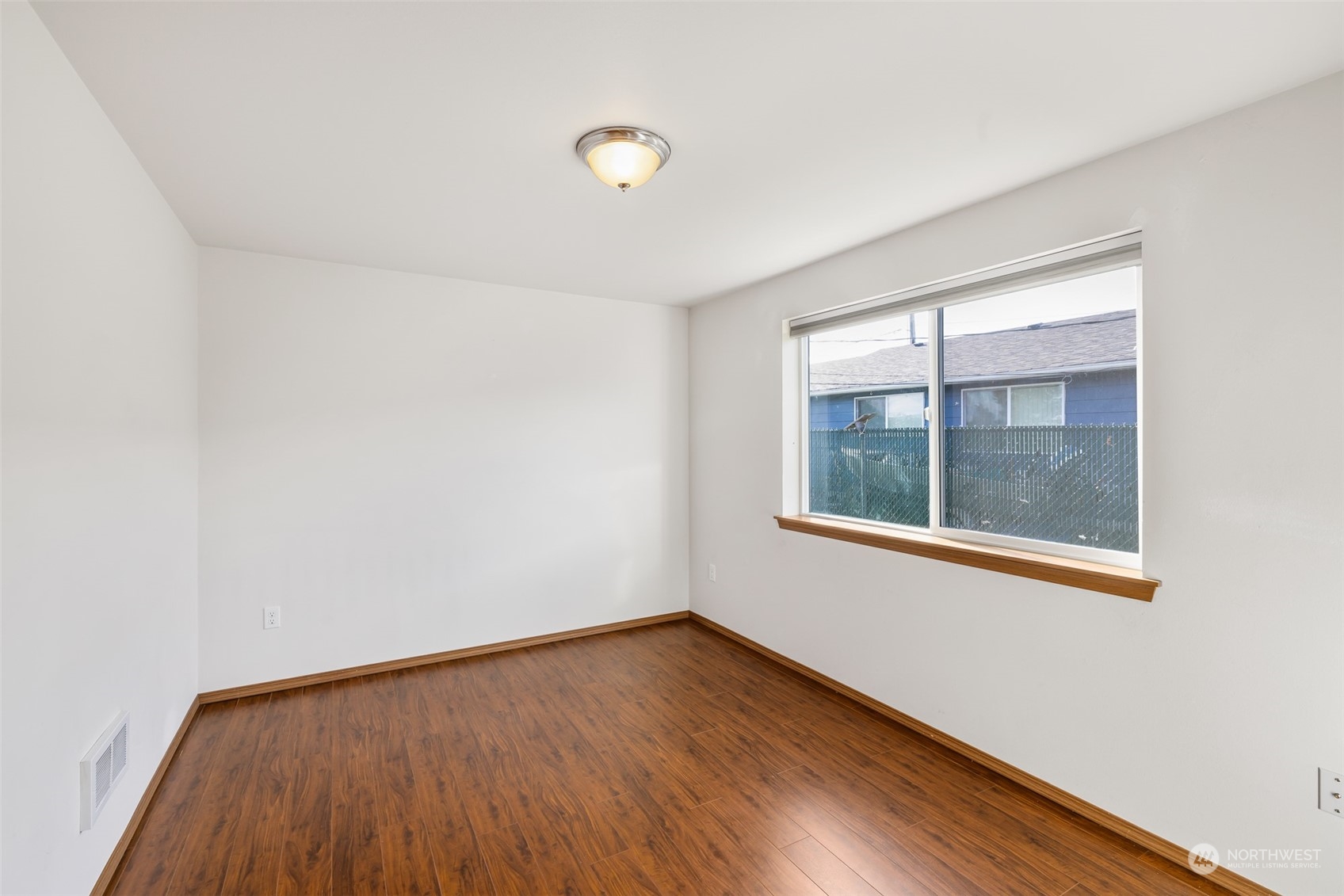 709 East Fir Street Sequim, WA 98382 - Photo 16 of 29 an empty room with wooden floor and windows