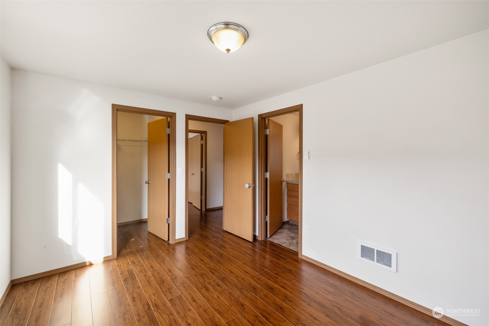 709 East Fir Street Sequim, WA 98382 - Photo 17 of 29 an empty room with wooden floor and windows