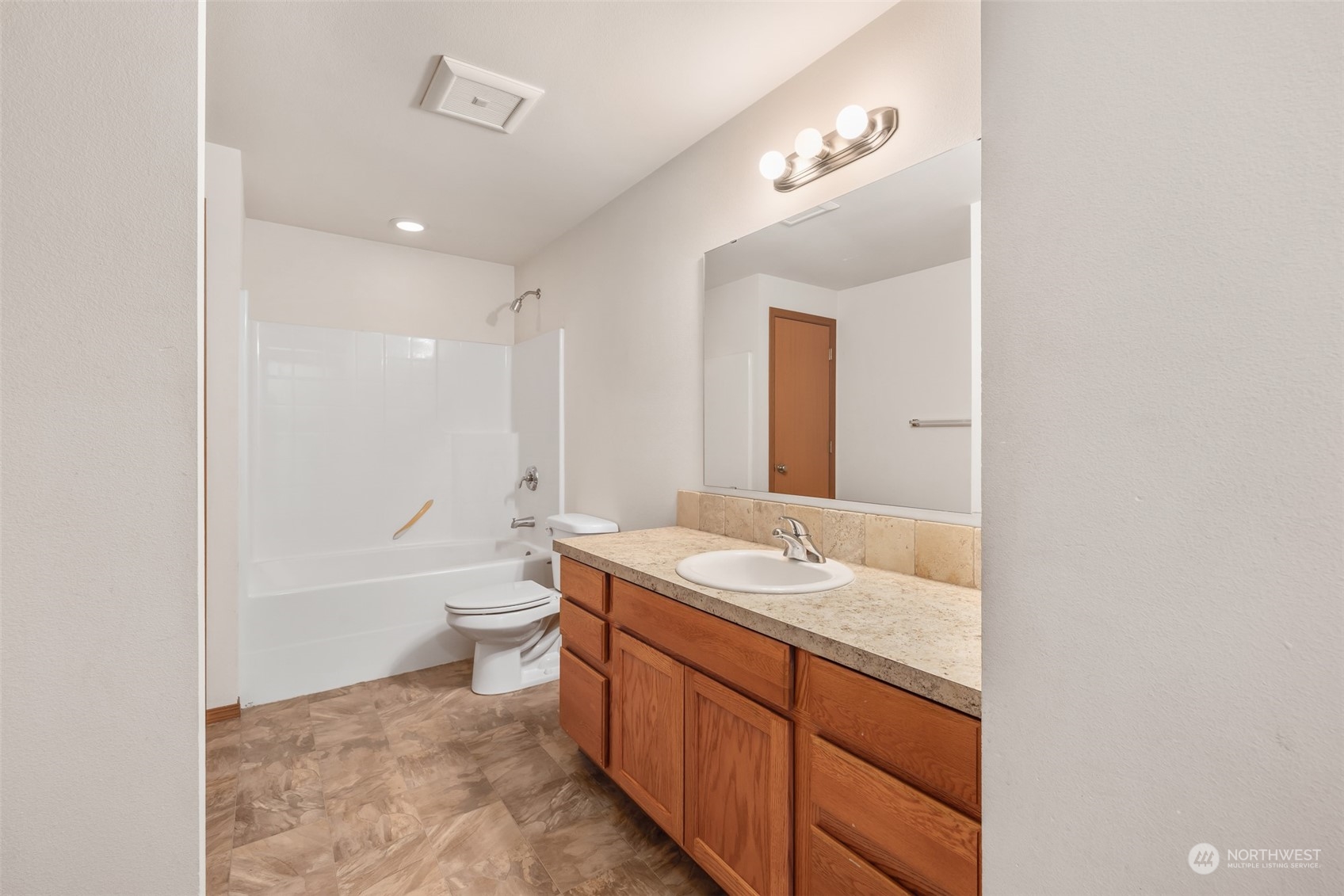 709 East Fir Street Sequim, WA 98382 - Photo 19 of 29 a bathroom with a granite countertop sink toilet mirror and bathtub