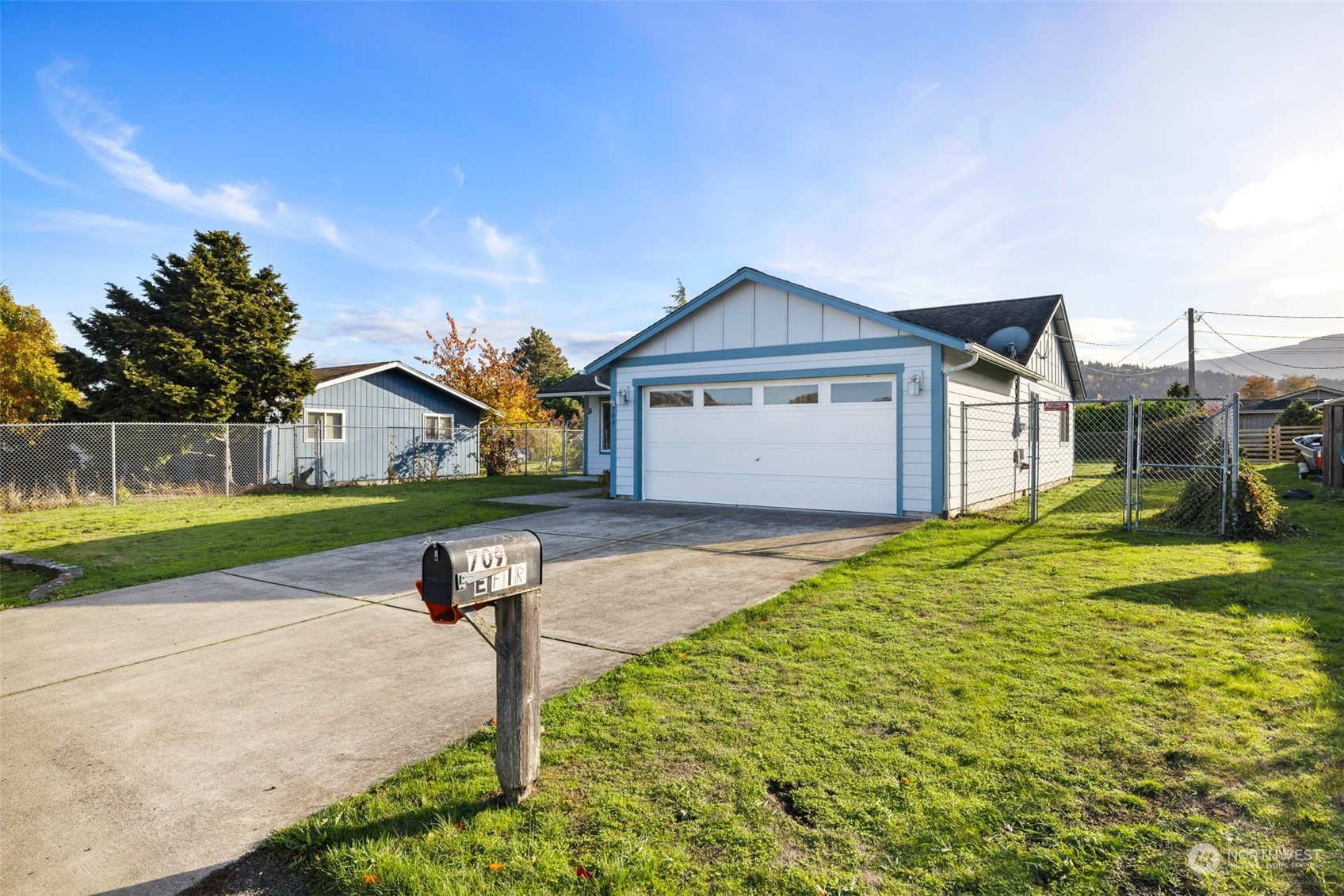 709 East Fir Street Sequim, WA 98382 - Photo 2 of 29 a front view of a house with a yard and garage