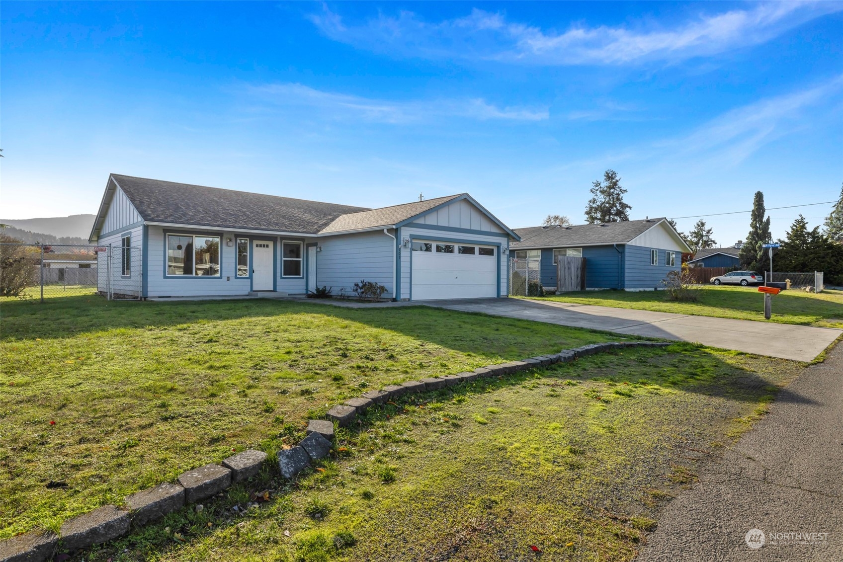709 East Fir Street Sequim, WA 98382 - Photo 3 of 29 a view of a big house with a big yard and large trees
