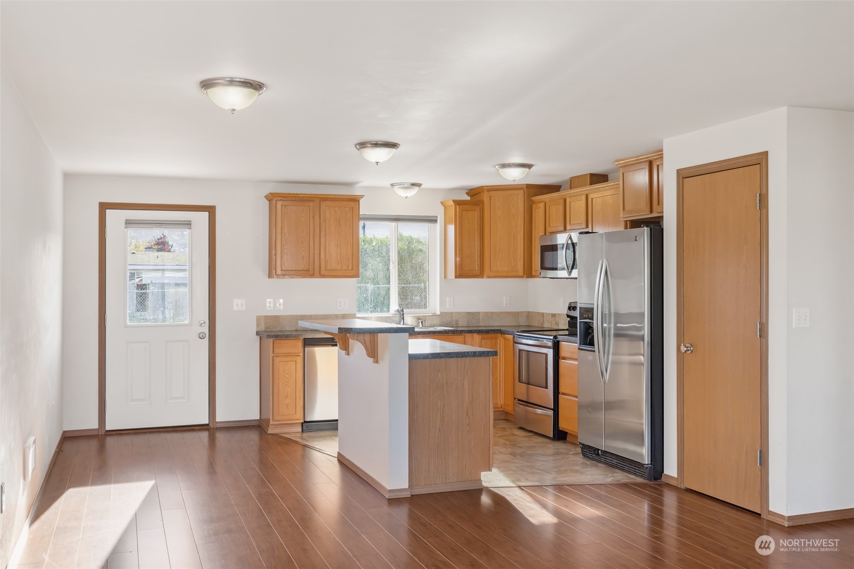 709 East Fir Street Sequim, WA 98382 - Photo 4 of 29 a kitchen with stainless steel appliances granite countertop a refrigerator a sink and a stove