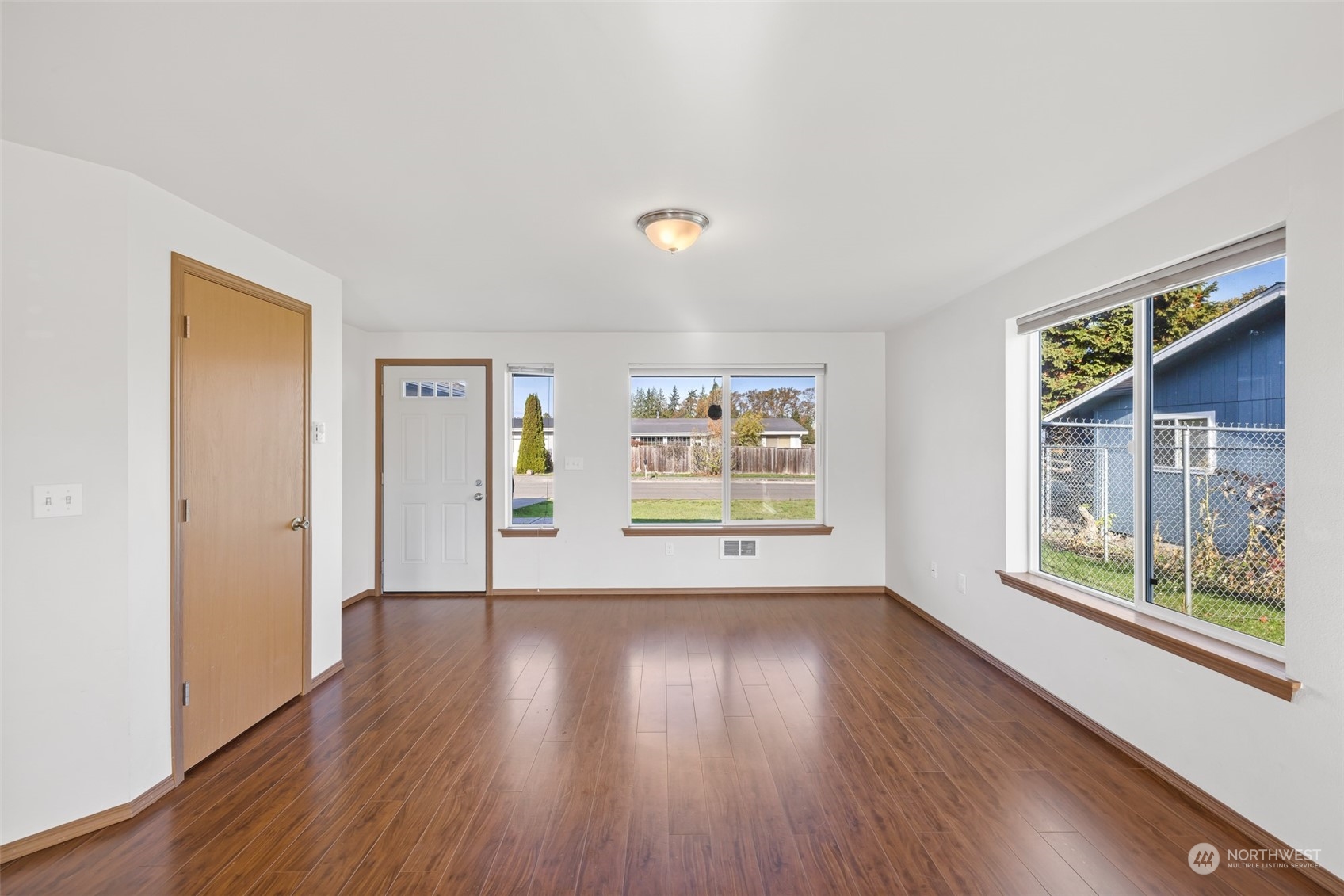 709 East Fir Street Sequim, WA 98382 - Photo 8 of 29 a view of an empty room with wooden floor and a window