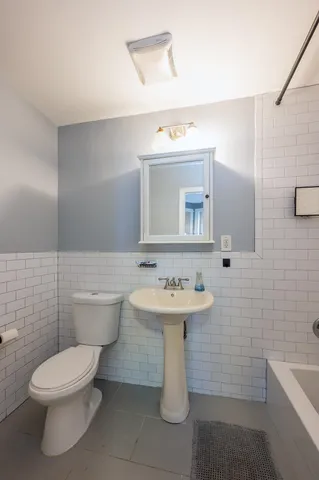 a view of walk in closet with clothes