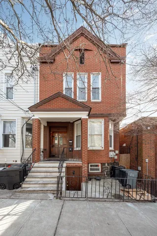 a front view of a building with sitting area