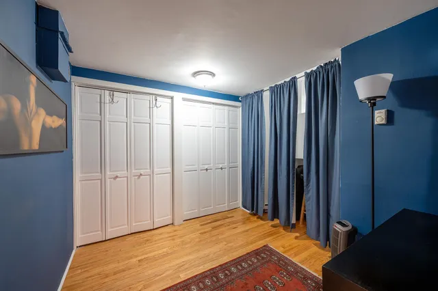 a bedroom with a bed and a cabinet