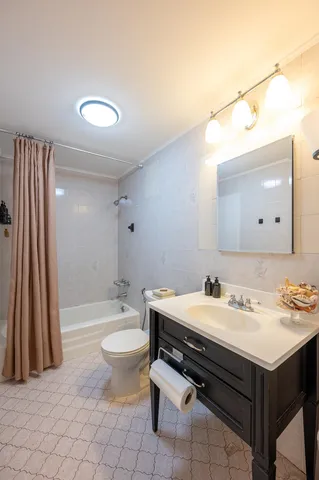a bathroom with a sink toilet and a mirror