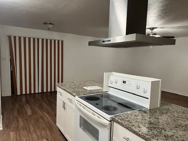 a kitchen with a stove and a microwave