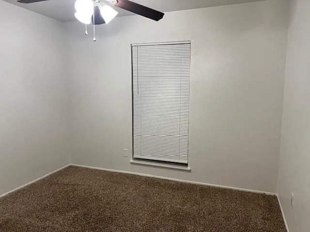 an empty room with a empty space and a ceiling fan