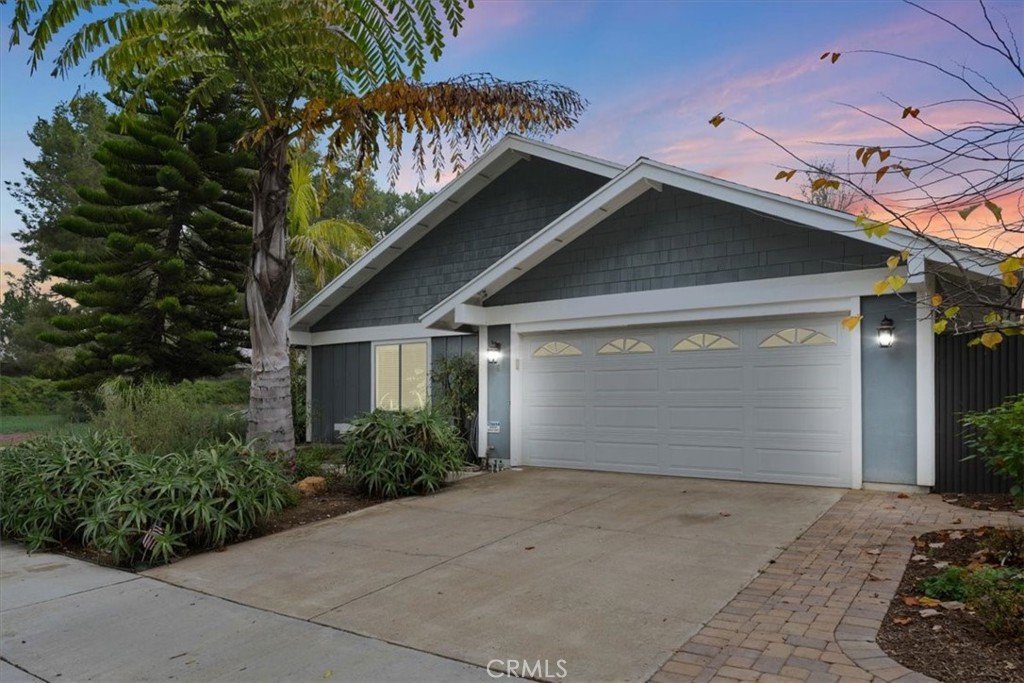 a view of a house with a yard and garage