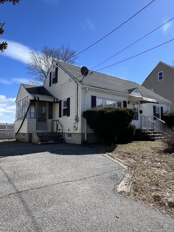 39 Phebe Avenue Lowell, MA 01854 - Photo 2 of 13 a front view of a house with a yard