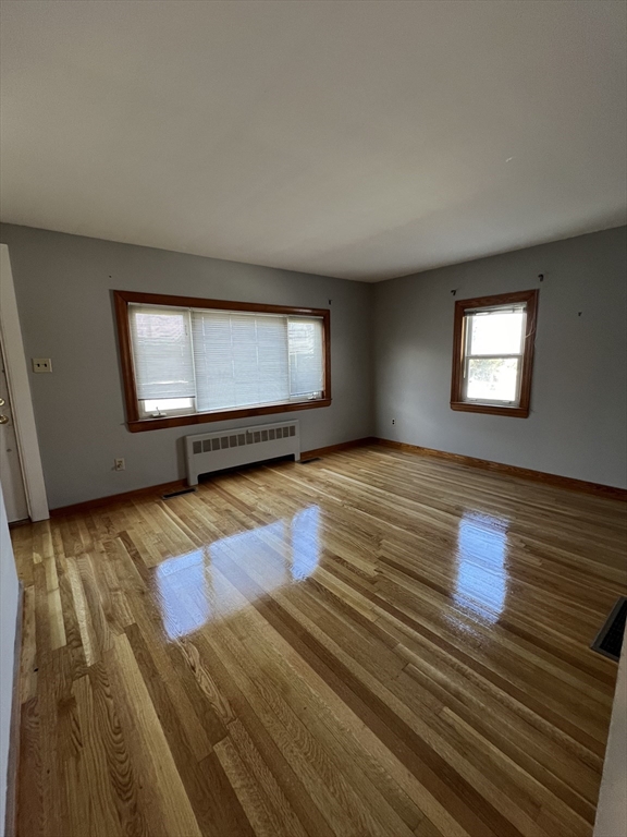 39 Phebe Avenue Lowell, MA 01854 - Photo 8 of 13 a view of empty room with wooden floor and fan