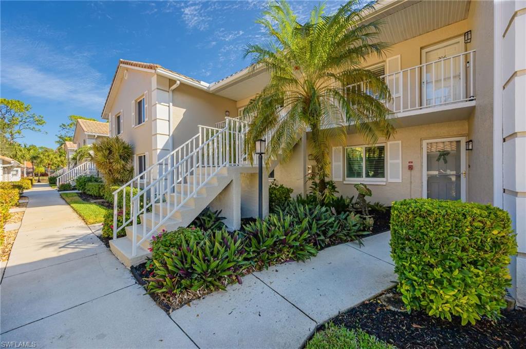 5940 Cranbrook Way, Unit A206 Naples, FL 34112 - Photo 1 of 50 a front view of a house having garden