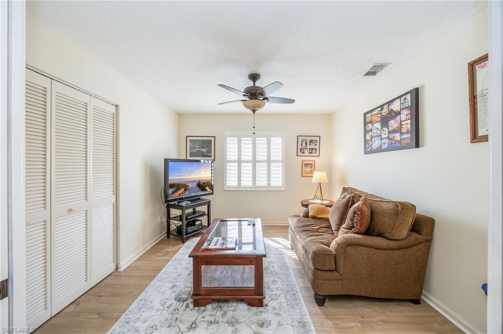 5940 Cranbrook Way, Unit A206 Naples, FL 34112 - Photo 12 of 50 a living room with furniture and a chandelier