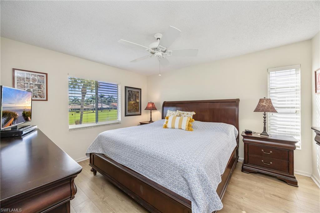 5940 Cranbrook Way, Unit A206 Naples, FL 34112 - Photo 13 of 50 a bedroom with a bed and a desk