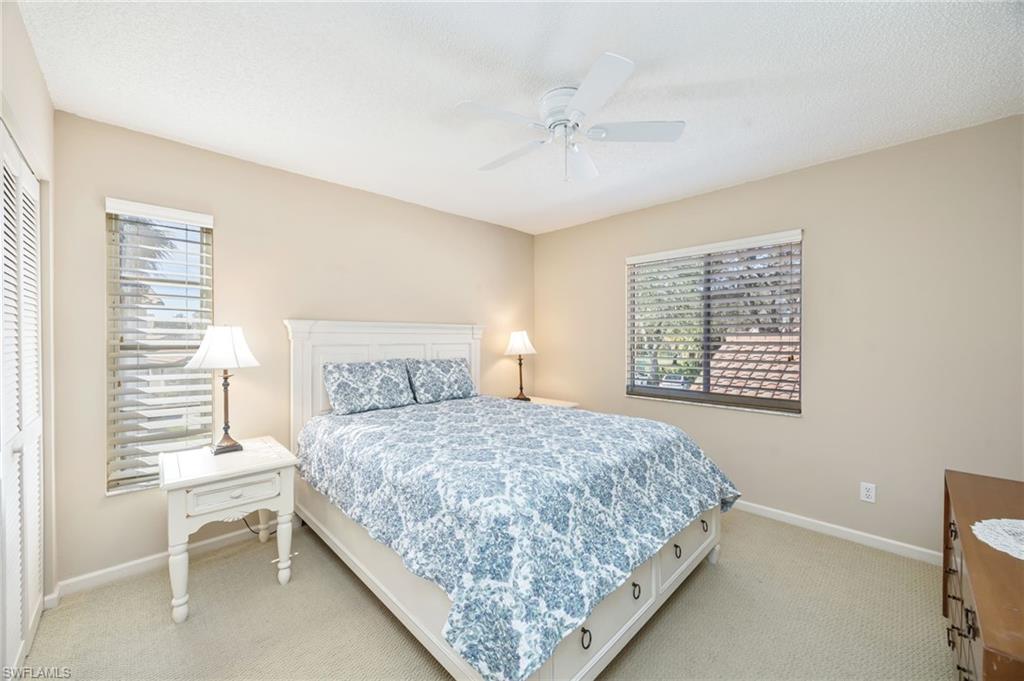 5940 Cranbrook Way, Unit A206 Naples, FL 34112 - Photo 15 of 50 a bedroom with a bed and a window