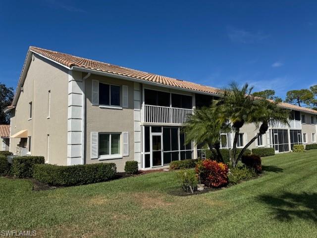 5940 Cranbrook Way, Unit A206 Naples, FL 34112 - Photo 4 of 50 a front view of a house with a garden