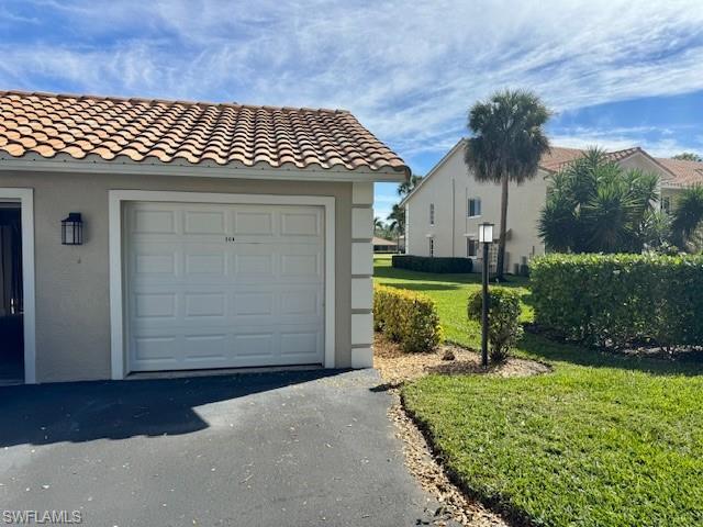 5940 Cranbrook Way, Unit A206 Naples, FL 34112 - Photo 6 of 50 front view of a house with a yard
