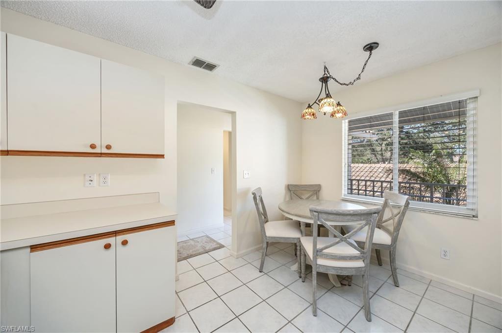5940 Cranbrook Way, Unit A206 Naples, FL 34112 - Photo 8 of 50 a view of a dining room with furniture and window