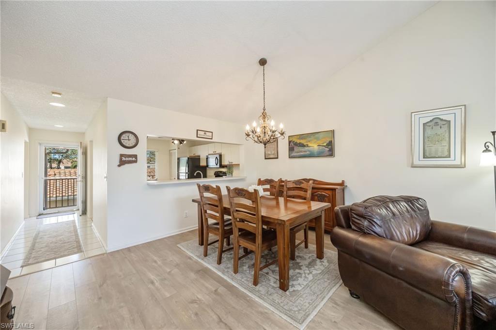 5940 Cranbrook Way, Unit A206 Naples, FL 34112 - Photo 9 of 50 a living room with furniture and wooden floor